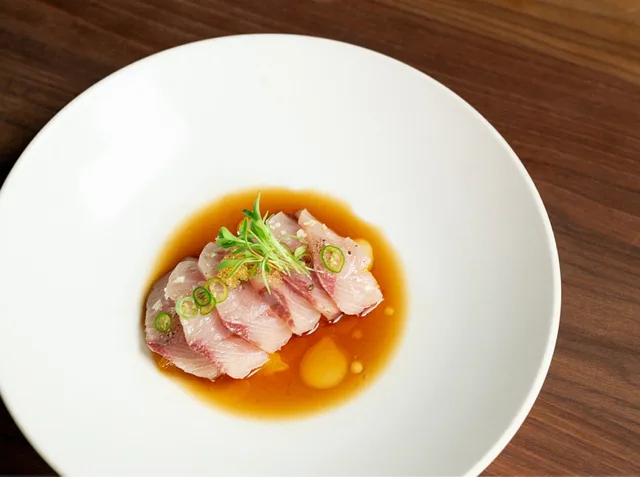 Uchi Austin hama chili, yellowtail with ponzu, Thai chili and orange.