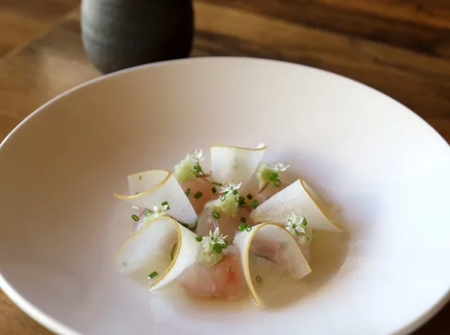Thinly sliced fish with pear and microgreens at Uchi Dallas.